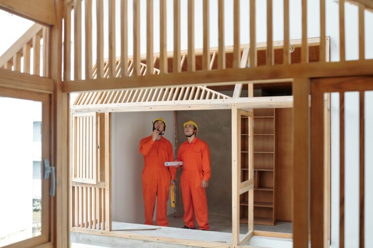 Contractors Discussing Wooden House Frame