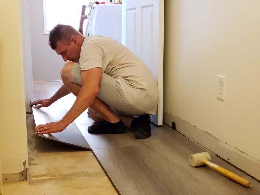 Floor level view of laminate flooring installation, home renovation, construction materials, tiles